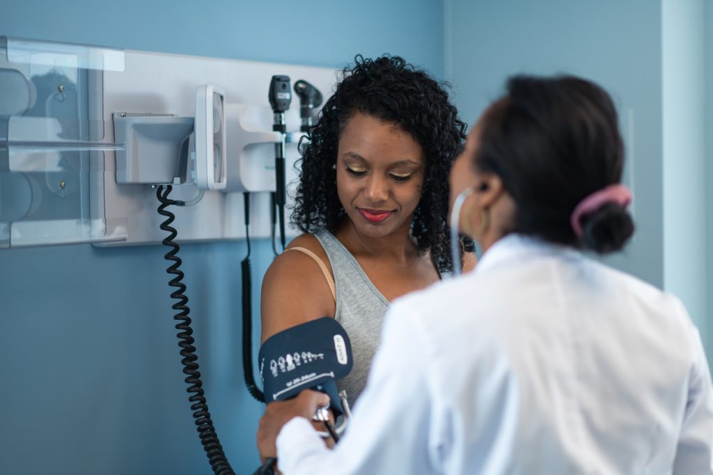 Young woman in medical consultation with female doctor