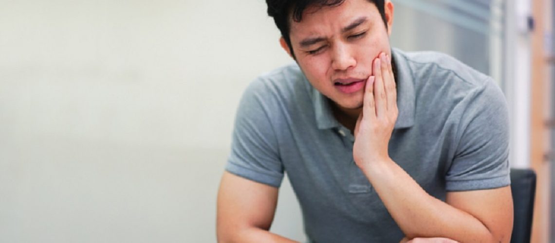 close up asian middle aged man feeling hurt from toothache symptom , unhealthy life concept