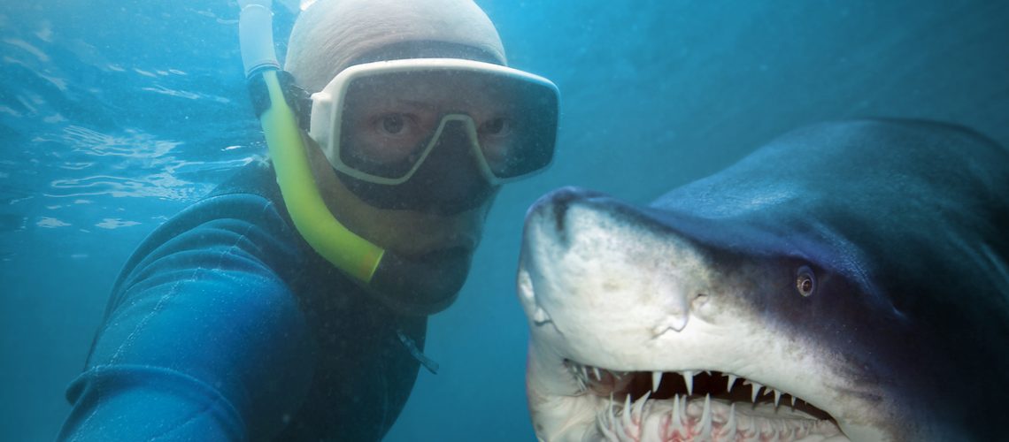 Underwater selfie with friend. Scuba diver and shark in deep sea.